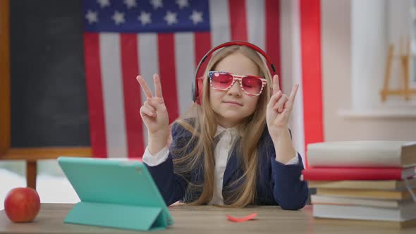 Joyful Carefree Teen Student Listening to Music in Headphones with Closed Eyes Gesturing Dancing