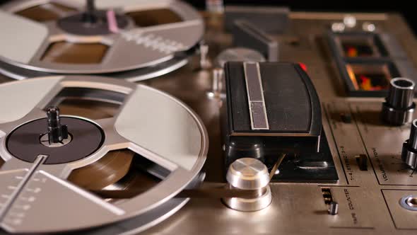 Vintage Reel to Reel tape recorder playing music close up of reel