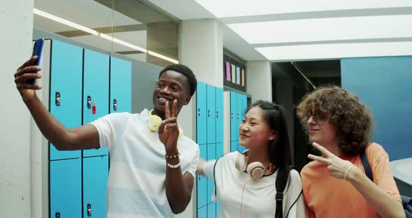 Three Multiethnic Teenage Students Take a Selfie at School
