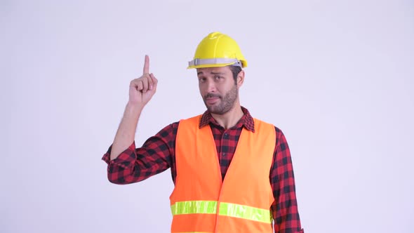 Happy Bearded Persian Man Construction Worker Pointing Up