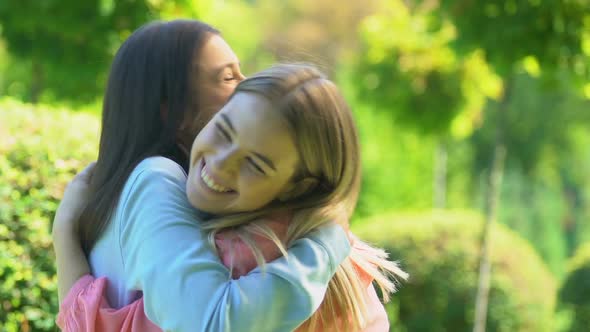 Joyful Female Millennials Friends Embracing After Parting, Long-Awaited Meeting