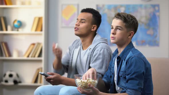 Teenagers Watching Show in TV and Throwing Popcorn in Mouth, Procrastination