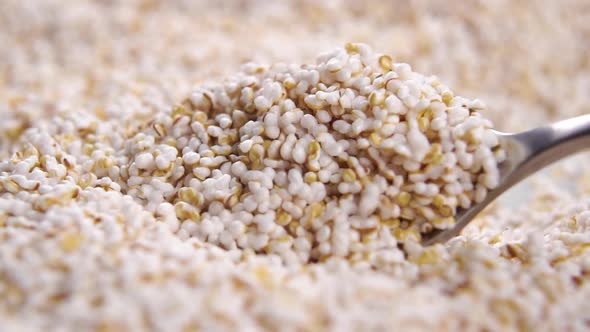 Amaranth puffed grain pile moving with spoon. Popped seeds of Amaranthus. Gluten free food