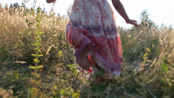 Little girl running through summer field