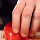 Hands is Cutting a Tomato with a Knife on Wooden Board Closeup - VideoHive Item for Sale