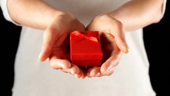 Close-up of hand holding small red gift box 4k