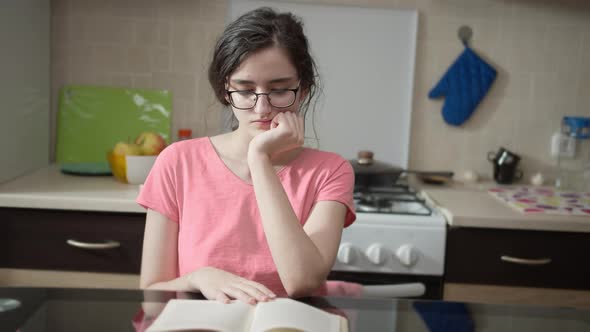 Girl Leafing Through Pages of a Book