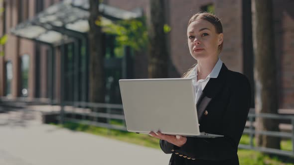 Business Woman with Laptop Posing Outdoors