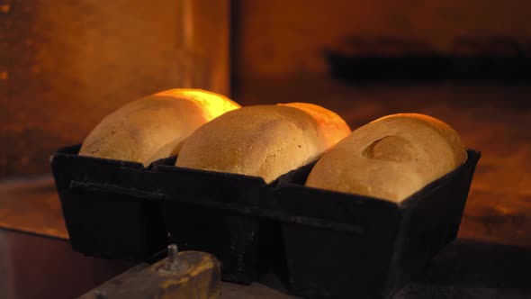 Rustic old retro oven that has lot of bread in it.