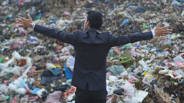 Businessman Enjoy With Mountain Of Garbage