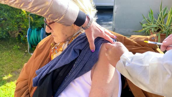 Elderly Woman in the 90s Getting Vaccinated for Covid19 Pandemic Outdoor