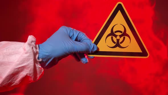 The Doctor Holds a Biohazard Sign in the Coronavirus Infection Area