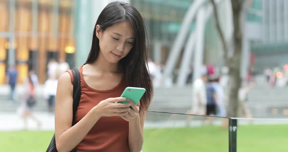 Woman use of mobile phone at outdoor 