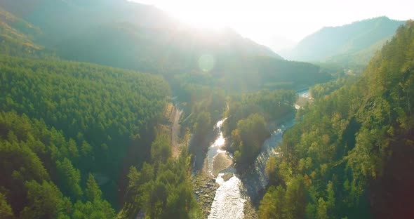 Low Altitude Flight Over Fresh Fast Mountain River with Rocks at Sunny Summer Morning