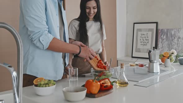 Latin Couple Talking While Cooking Together