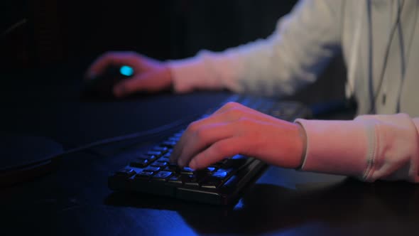 Close-up On Gamer's Hands on a Keyboard, Actively Pushing Buttons, Playing MMO Games Online