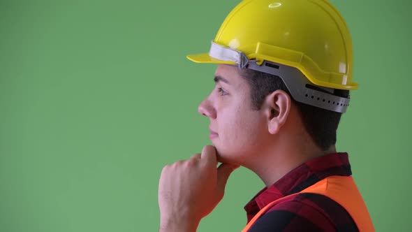 Closeup Profile View of Happy Young Multi Ethnic Man Construction Worker Thinking