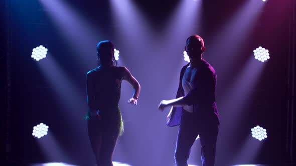 A Couple of Professional Ballroom Dancers Dance To Latin Music and Move Their Hips Passionately