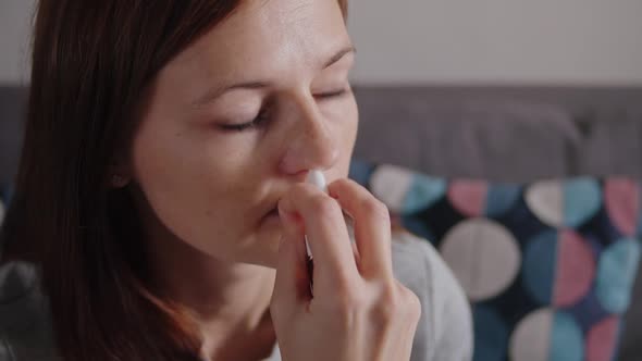 A Woman Applying a Therapeutic Nasal Spray