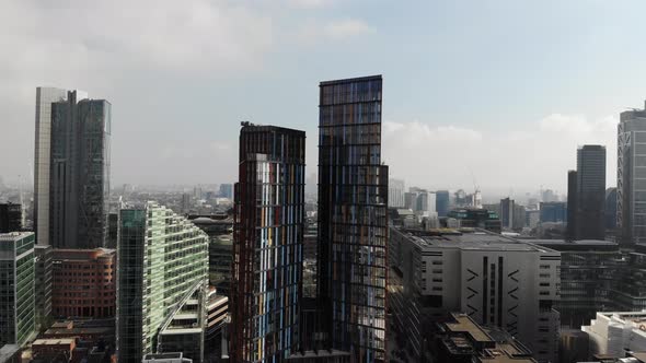 Aerial view of skyscrapers near Liverpool Street Station on a hazy day in London