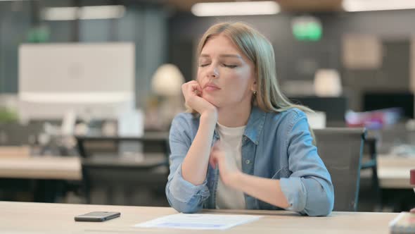 Young Woman Taking Nap in Modern Office