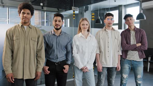 Young Happy Employees Stand in Row Looking at Camera Smiling Diverse Different Colleagues Posing in