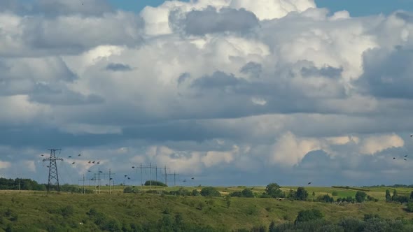 Time Lapse Footage of Fast Moving White Puffy Cumulus Clouds on Blue Clear Sky Over Power Lines