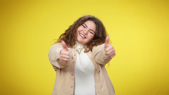 Happy Excited Young Overweight Woman Showing Thumbs Up Looking at Camera Smiling