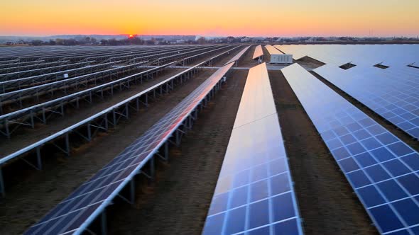 Close up drone view of solar panels stand in a row in the fields, HDR 4k footage