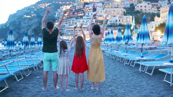 Family in Front of Positano on the Amalfi Coast in Italy in Sunset