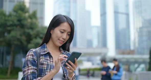 Woman read on mobile phone in city