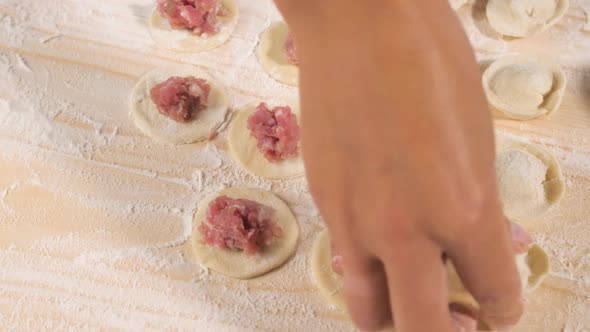 Female Hands of a Cook Take a Blank