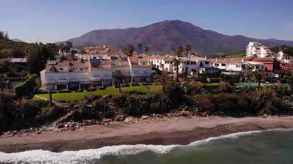 Holiday Apartments At The Beach In Estepona, Costa Del Sol, Spain In Summer. drone descend
