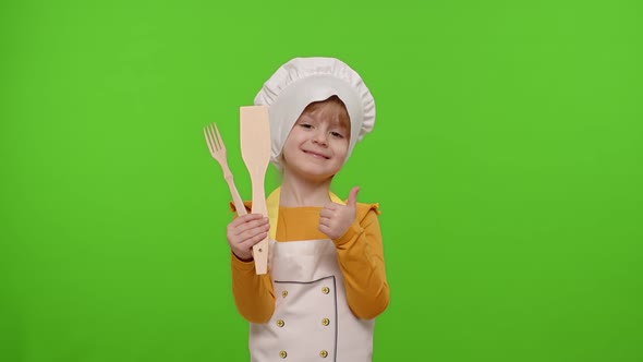 Child Girl Cook Chef Baker in Apron and Hat Smiling Nods Head in Agreement on Chroma Key Background