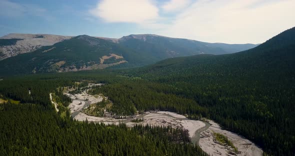 Aerial Daytime Wide Shot Moving Right Fast And Turning Left To Reveal Bends Of A Swift Steep River F