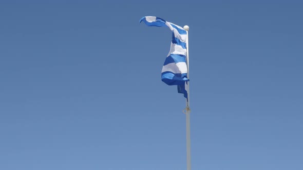 Flag of Greece against blue sky waving 4K 2160p 30fps UHD footage - Greek national symbol silky fabr