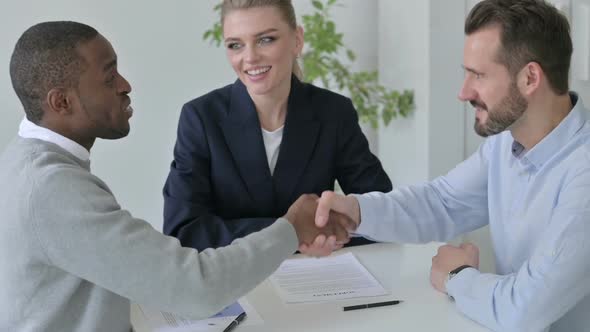 Slow Motion of Mixed Race Business People Shaking Hands in Office