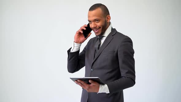 Professional African-american Business Man Holding Tablet Pc and Talking on the Phone
