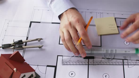Architect Hands with Ruler Measuring Blueprint