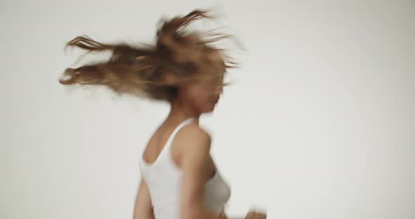 Beautiful Young Woman Jumping In Studio