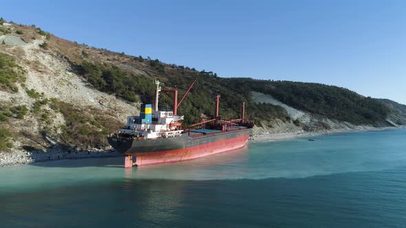 Sunny Landscape With Moored Tanker Vessel Ship Near The Slope Covered