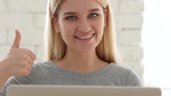 Thumbs Up by Confident  Woman Sitting in Office