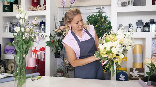 Woman Professional Florist Makes Huge Flower Bouquet in Floristic Studio