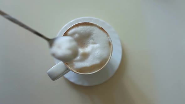 milk foam in a large cup of cappuccino coffee