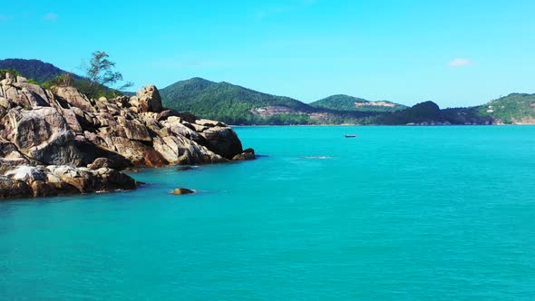 Aerial nature of beautiful seashore beach time by blue lagoon and white sandy background of a daytri