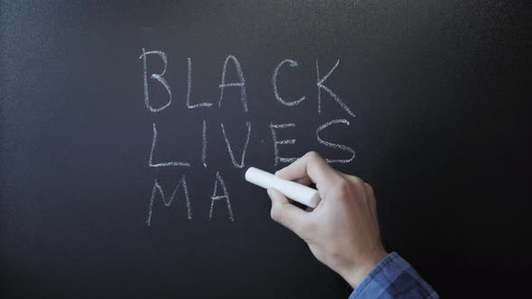 Black lives matter written on chalkboard. BLM.