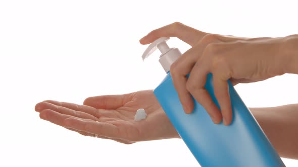 Body Cream From a Blue Plastic Bottle is Squeezed Into the Palm of your Hand