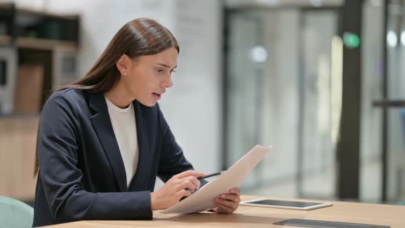 Disappointed Businesswoman with Documents Reacting to Failure