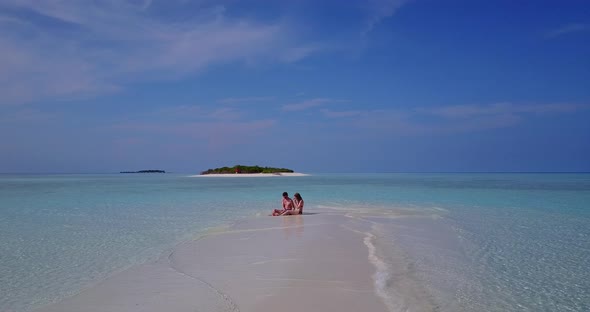 Beautiful man and woman on honeymoon vacation enjoy luxury on beach on paradise white sand 4K backgr