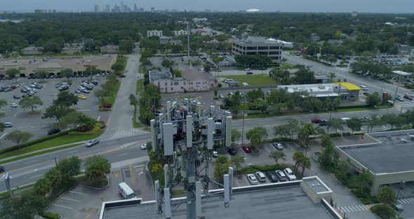 4K Aerial video of cellular tower technicians servicing antennas